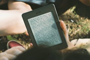 Person reading a book on a Kindle